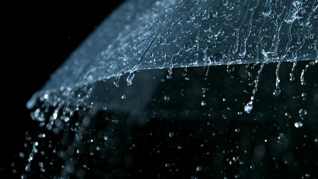 Rain drops on transparent umbrella, super slow motion filmed on high soeed cinematic camera at 1000 fps