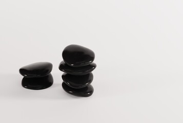 Black decorative stones on a light background. The concept of furnishing a room, apartment, house. Black pebbles. 3D render, 3D illustration.