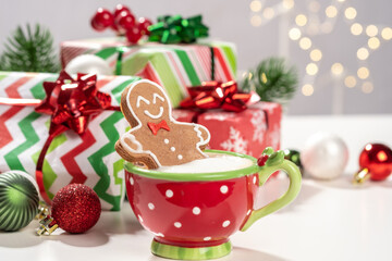 Gingerbread cookie man in a cup of hot chocolate or cappuccino