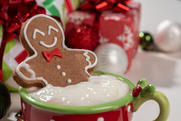 Gingerbread cookie man in a cup of hot chocolate or cappuccino