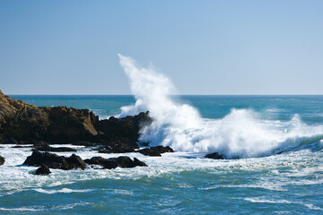 Ocean waves break against rocky outcrops along the Central Coast of California