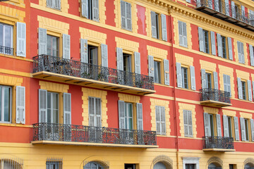 Fototapeta na wymiar Colourful Exterior of Building with windows and balcony in Monaco