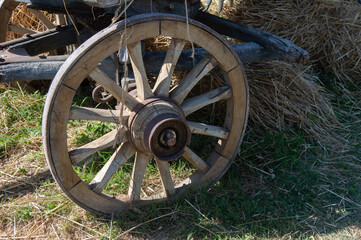 Fototapeta premium An old wooden cart for transporting hay and straw, with an iron-hooped wooden one. Used on farms in the countryside