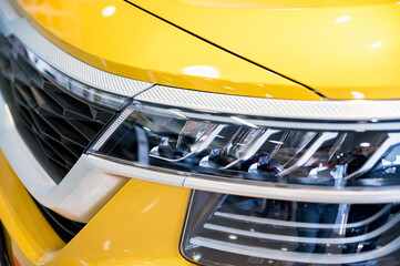 Close-up image of headlights of white modern car