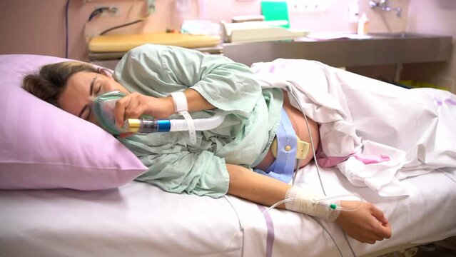 a woman during labor and delivery at the hospital. pregnant woman having contractions in the hospital. birth pains. Pregnant Woman In Labor At Hospital