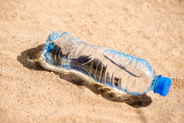 A bottle of drinking water on the sea beach
