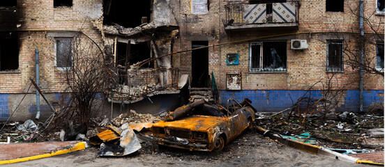 Buildings and car damaged by Russian bombs.