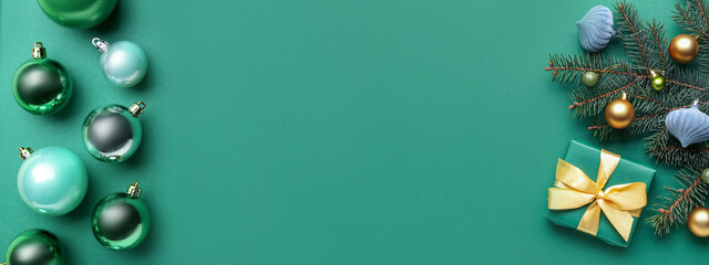 Beautiful Christmas composition with gift and decor on green background with space for text