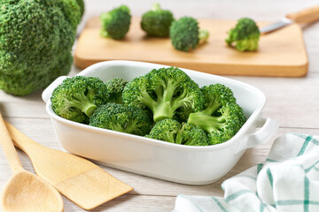 raw organic broccoli in baking dish, preparation for baking in the oven , top view.