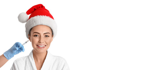 Young woman in Santa hat receiving filler injection against white background with space for text