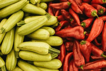 Green zucchini and red paprika close up.