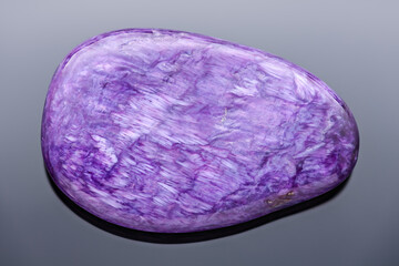 Charoite tumblestone - Very sharp and detailed photo of a rare and beautiful stone that can be only found in the Republic of Sakha (Yakutia, Russia).