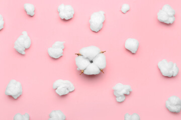Soft cotton wool and flower on pink background