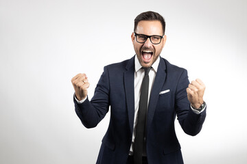 Studio portrait of business man showing happy emotions, showing success. Portrait on white background, isolated