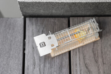 Metal mousetrap with cheese outdoors