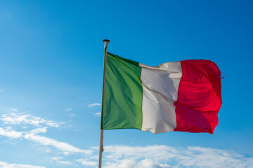 Italian Flag Waving against blue sky 