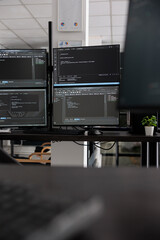 Computer screens showing compiling html code in empty developing office, security system parsing...