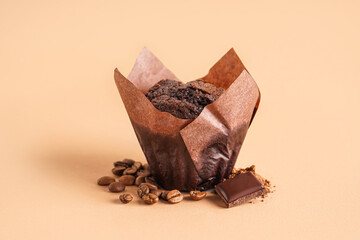 Sweet chocolate muffin on color background