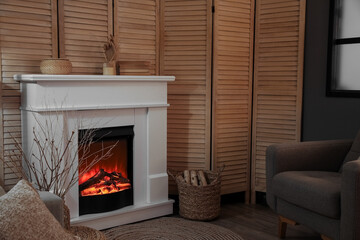 Modern electric fireplace in interior of dark living room