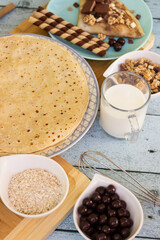 Crepes with chocolate on cutting board with ingredients