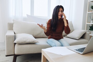 Woman talking on phone angry and sad at home, fight over phone throwing papers, bad news at work and family