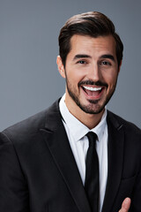 Portrait of a business man with a natural smile with teeth on a gray background in a business suit. Business portrait of a stylish man copy space