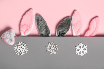 Bunny ears with snowflakes on pink and grey background
