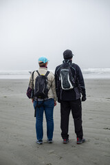 Active Senior Couple enjoying the view As They Walk Through Sand Dunes by the ocean