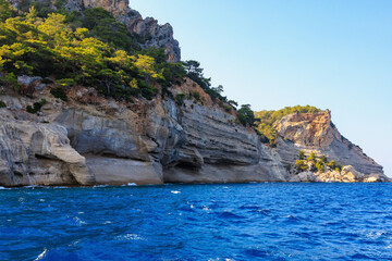 View of the rocky shore from the sea. Mediterranean Sea in Turkey. Popular tourist places. Background