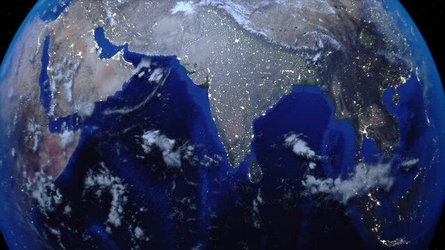 Zoom out of India through clouds to see the Earth from space.