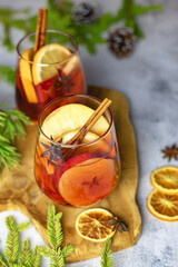 Glasses of hot fragrant mulled wine with pieces of fresh fruit and spices, cinnamon and anise....