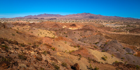Sara Mountain Park trails and city skyline of Lake Havasu City over the desert plain, Arizona
