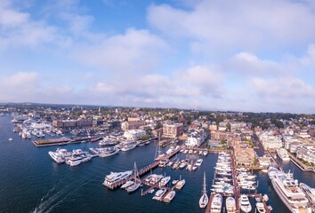 Aerial shot of the Newport Harbor in Rhode Island with ducked boats and a cloudscape