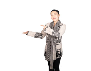 Chinese Japanese Asian woman standing smiling happy points gestures and presents in a fall autumn winter sweater in studio on white background with room for copy