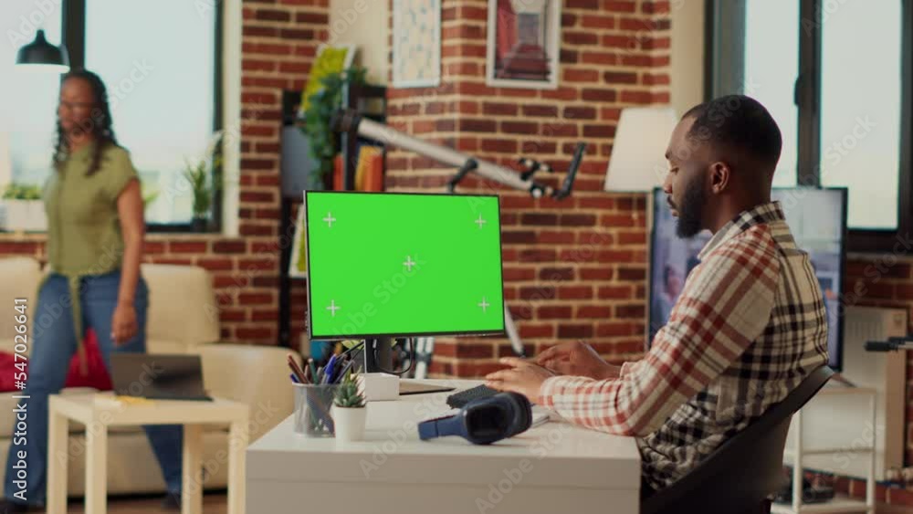 Aufkleber african american man analyzing greenscreen display on computer, looking at isolated template on pc a