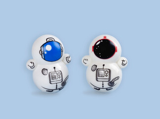 two toy astronauts on a blue background. toy tumblr