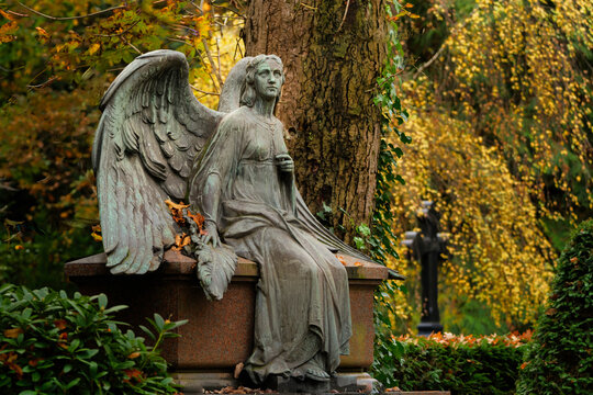 angel with spread wings on a cemetery in autumn mood