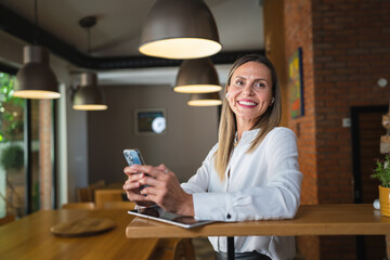 One caucasian woman adult entrepreneur using mobile phone at work