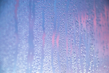 Naklejka na ściany i meble Texture of misted glass in winter. Frozen drops of water in sun on window.