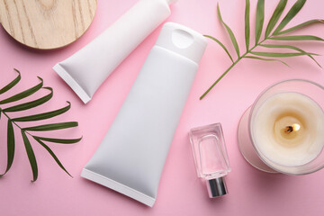Flat lay composition with different hand care cosmetic products on pink background