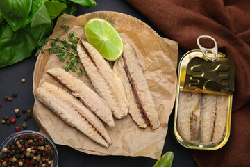 Canned mackerel fillets served on black table, flat lay - obrazy, fototapety, plakaty