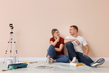 Fototapeta premium Happy couple discussing interior details in apartment during repair