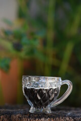 coffee cup on rustic wooden base with blurred background
