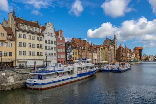 Beautiful shot of the beautiful old town buildings and water trams at the river in Gdansk, Poland