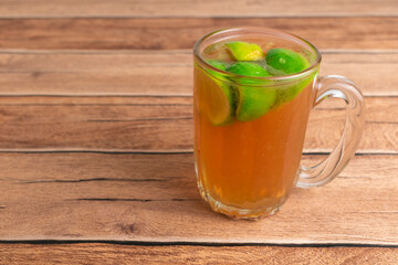 homemade hot tea with slice fresh lime on top. herbal drink for refreshing