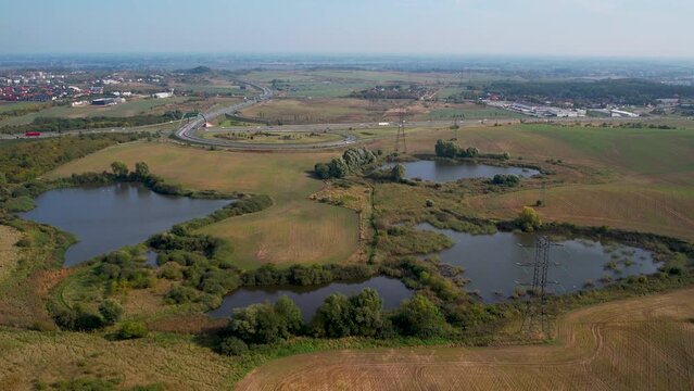 Aerial View Of Swamp In The Fields Near The Expressway S6 Road In Jankowo Gdanskie Village in Poland. - pullback