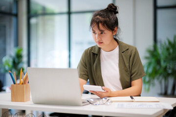 Young asian business woman or student working online on computer laptop.