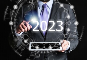 Young businessman hand with 2023 numbers
