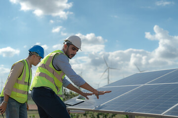 engineer man inspects construction of solar cell panel or photovoltaic cell by electronic device....