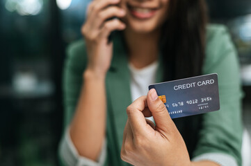 Young businesswoman paying order having contactless payment with cardit card